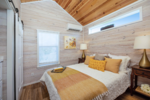 Grande tiny home bedroom with vaulted ceiling.