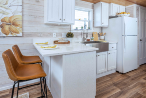 Grande tiny home kitchen with light cabinets and countertops.