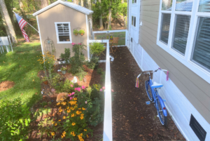 Side yard and flower garden with shed.