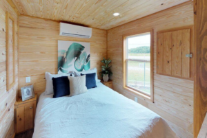 Echoe tiny home bedroom interior with natural shiplap walls.