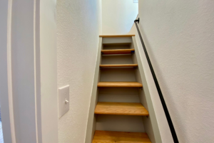 Stairs leading to loft space located above the kitchen and bedroom area
