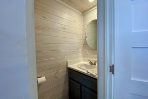 Half bathroom in tiny home with sink and toilet.