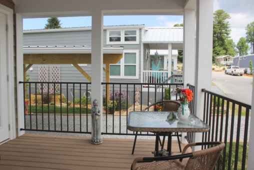 Covered front porch with bistro table and chairs.