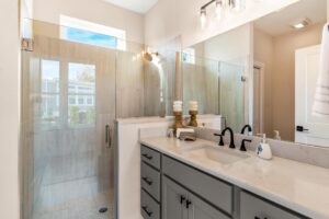 double sink vanity in owner bathroom with walk in shower