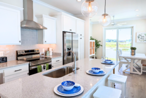 Sunny Isle cottage kitchen and dining room with rear sliding glass door.