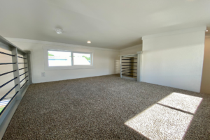 This carpeted loft space can be used as a lounging area, second sleeping area, storage and more