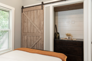 The bedroom in this tiny home model is large and has a lot of storage.
