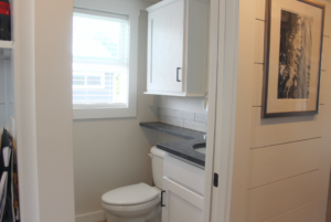 Bathroom with cabinet storage and extra shelf space.