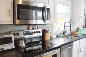 Stainless steel microwave, oven, and dishwasher in kitchen.