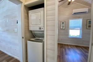 Laundry nook in hallway with stackable washer and dryer