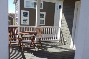 Covered front porch with bistro table and chairs.