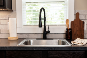 Large sink in kitchen of small home located in a gated community in north carolina.