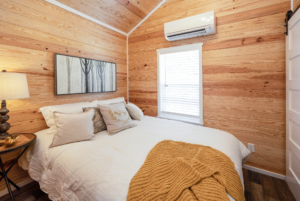 Tiny home bedroom featuring queen sized bed.