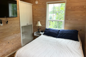 Tiny home bedroom with built-in storage.