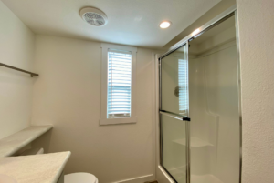 This small bathroom includes a large walk in shower