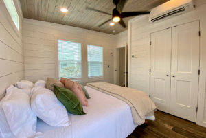 bedroom with large windows, high ceiling, ceiling fans and large closet