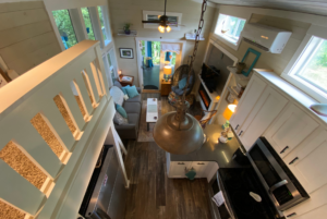 View of living space from the loft in tiny home with high ceillings.