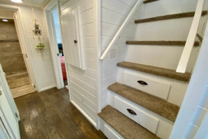 Stairs leading to loft space of tiny home.