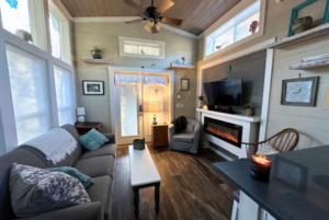tiny home living room with fireplace and large windows