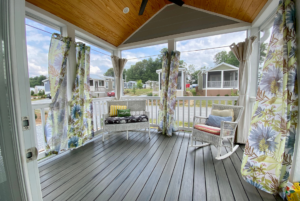 Large covered front porch connected to tiny home.