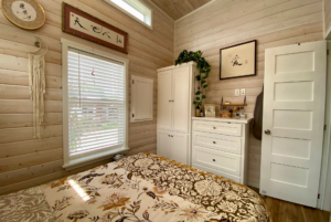 Built-in storage in bedroom of tiny home.