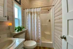 large shower with seating area in tiny home.