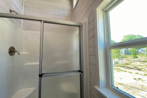 bathroom in tiny home with walk in shower and large window