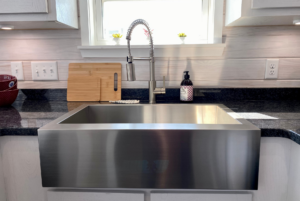 Modern stainless steel farm house sink in tiny home kitchen