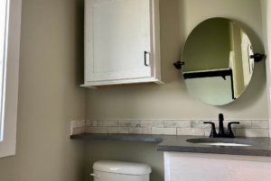 bathroom with upgraded counter and storage space