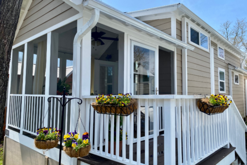 Front of lovely tiny home with added covered front porch