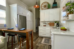 Kitchen of tiny home with full size appliances.