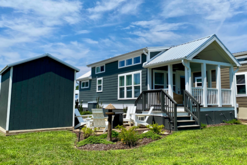 This tiny home comes with a nicely landscaped lot and a fire pit space.