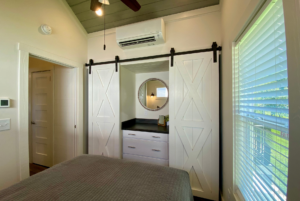 His and Hers closet with built in furniture and sliding barn doors.