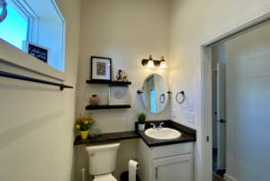 Bathroom in tiny home with floating shelves