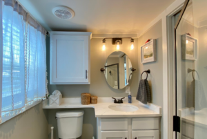 Bathroom in tiny house with plenty of storage and natural light.