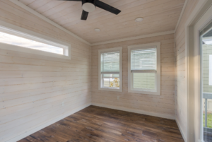 Bedroom with high ceillings and large windows.