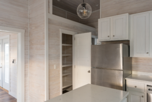 This tiny home comes with ample kitchen storage.