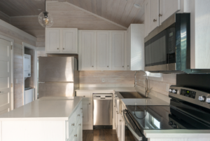 Nicely sized kitchen in tiny home with center island and ample storage.