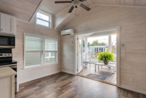 Lovely living room in tiny house with large windows and high ceilling.