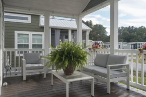 Lovely covered porch at the front of tiny house.