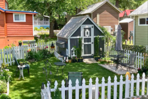 backyard with shed and large green space with fence