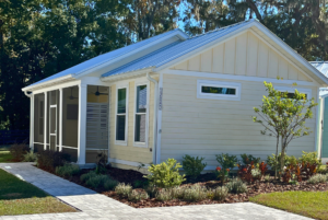 lovely home with light yellow exterior color and metal roof