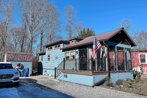 front of light blue tiny home