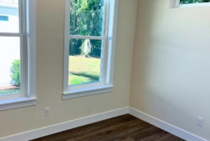 Large windows in bedroom with view of the preserve