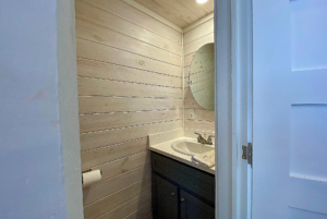 View of half bathroom from tiny home hallway