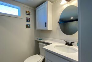 bathroom with medecine cabinet above toilet and single sink