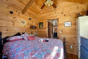 tiny home bedroom with high ceilling and ceilling fan