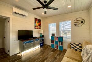 High ceiling living room with wall AC and ceilling fan