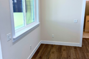 View of dinning room/living room space with large window and luxury flooring