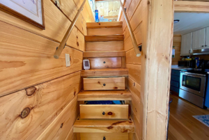 stairs to loft in tiny home with storage